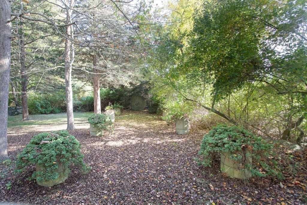 17 Quail Trail Westport, MA 02790 - Photo 37 of 40 a view of a yard with plants and large trees