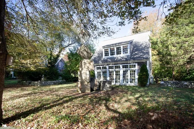 a front view of a house with a garden