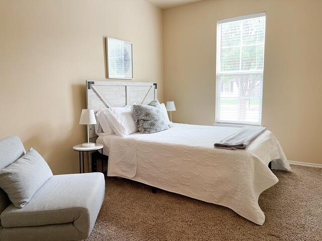 2116 10th Street Lubbock, TX 79401 - Photo 11 of 22 a bedroom with a bed and window
