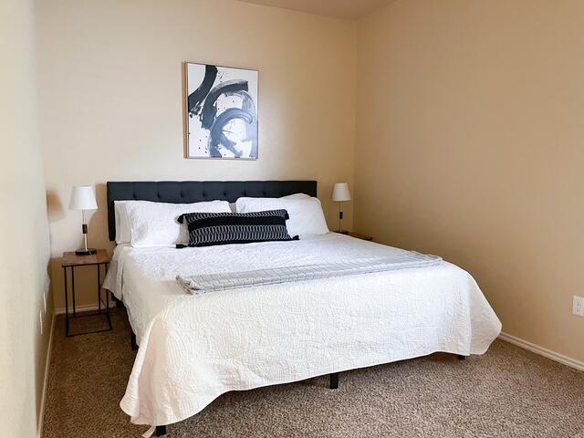 2116 10th Street Lubbock, TX 79401 - Photo 12 of 22 a bedroom with a bed and a night stand