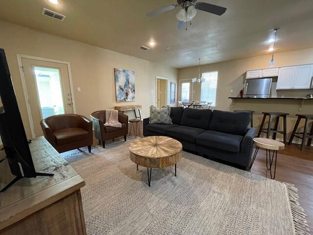 2116 10th Street Lubbock, TX 79401 - Photo 18 of 22 a living room with furniture and a wooden floor