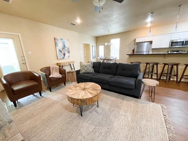 2116 10th Street Lubbock, TX 79401 - Photo 19 of 22 a living room with furniture and a wooden floor