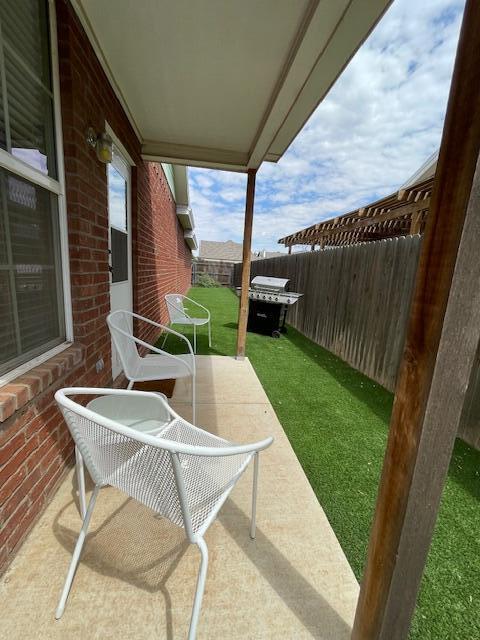 2116 10th Street Lubbock, TX 79401 - Photo 21 of 22 a patio with table and chairs
