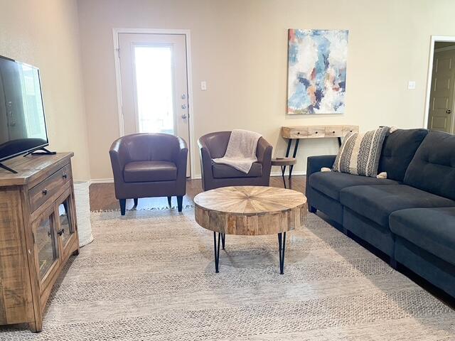 2116 10th Street Lubbock, TX 79401 - Photo 3 of 22 a living room with furniture a piano and a flat screen tv