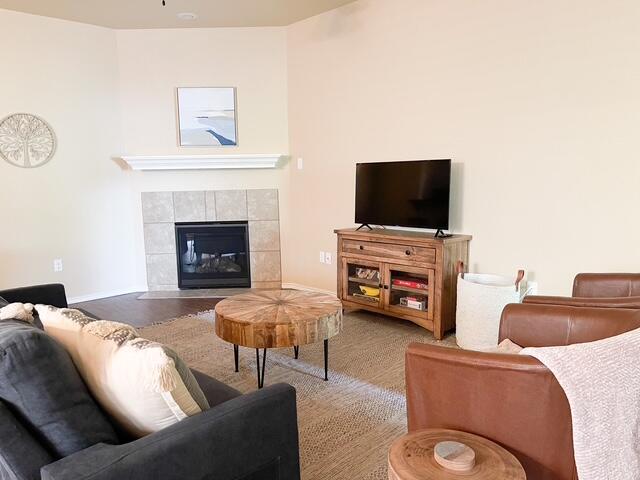 2116 10th Street Lubbock, TX 79401 - Photo 5 of 22 a living room with furniture a flat screen tv and a fireplace