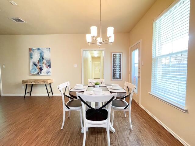 2116 10th Street Lubbock, TX 79401 - Photo 6 of 22 a view of a dining room with furniture window and wooden floor