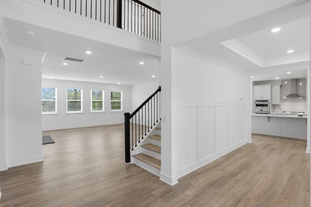 293 Deer Valley Run Canton, GA 30115 - Photo 2 of 8 a view of a hallway with wooden floor and kitchen