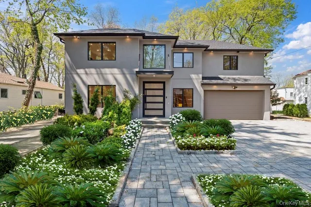 a front view of a house with garden