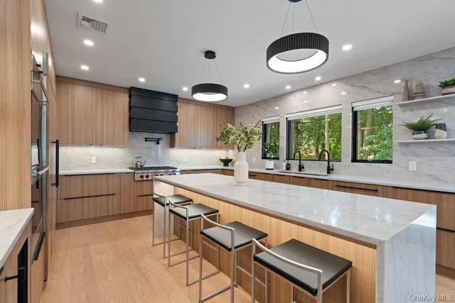 a large kitchen with a large window and stainless steel appliances