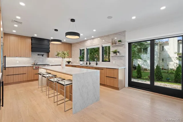 a kitchen with stainless steel appliances granite countertop a stove and a sink