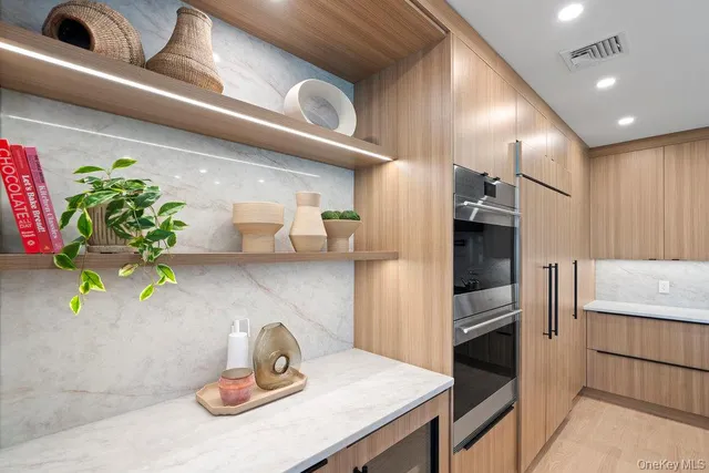 a kitchen with furniture and a potted plant