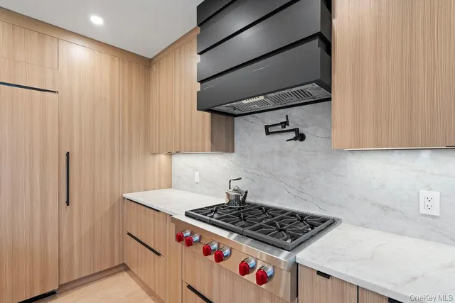 a kitchen with granite countertop a stove and a sink