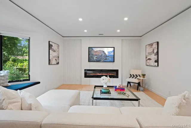 a living room with furniture and a hard wood floor