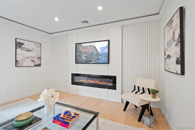 a living room with furniture and a painting on the wall