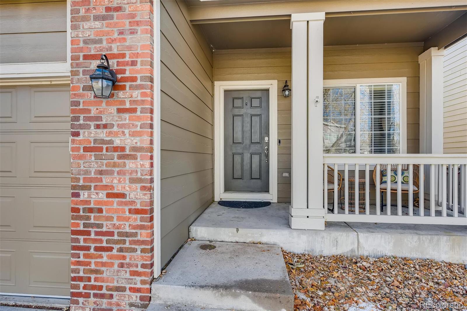 1118 Riddlewood Lane Highlands Ranch, CO 80129 - Photo 3 of 40 a view of a brick house with a window