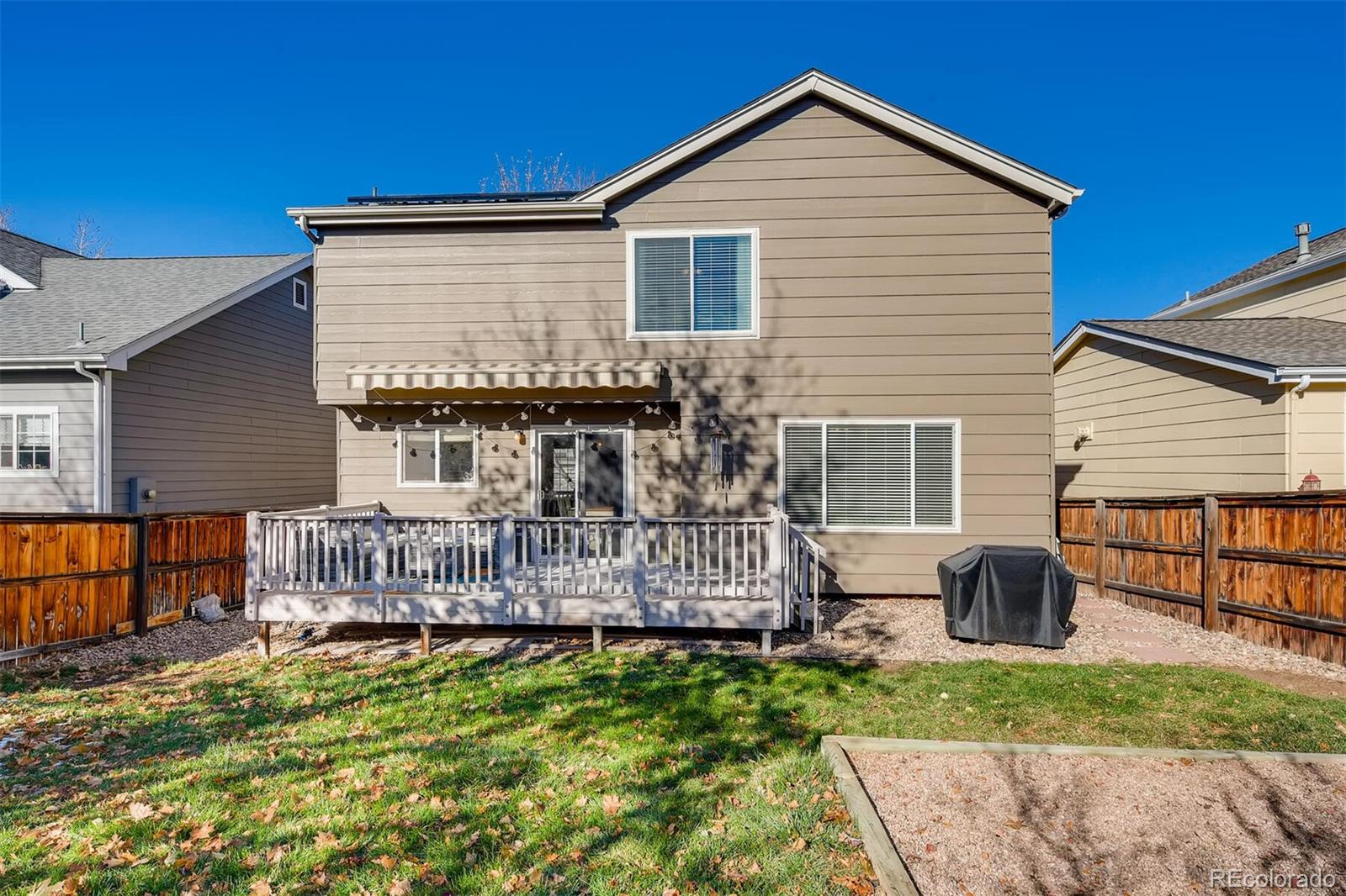 1118 Riddlewood Lane Highlands Ranch, CO 80129 - Photo 39 of 40 a view of a house with a yard and wooden fence