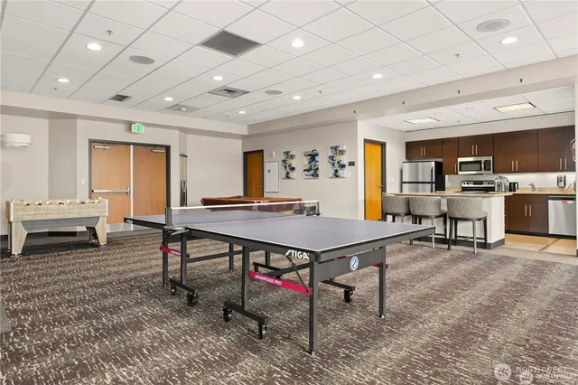a living room with furniture a pool table and a fireplace
