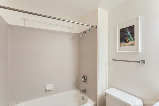 a bathroom with a shower and toilet