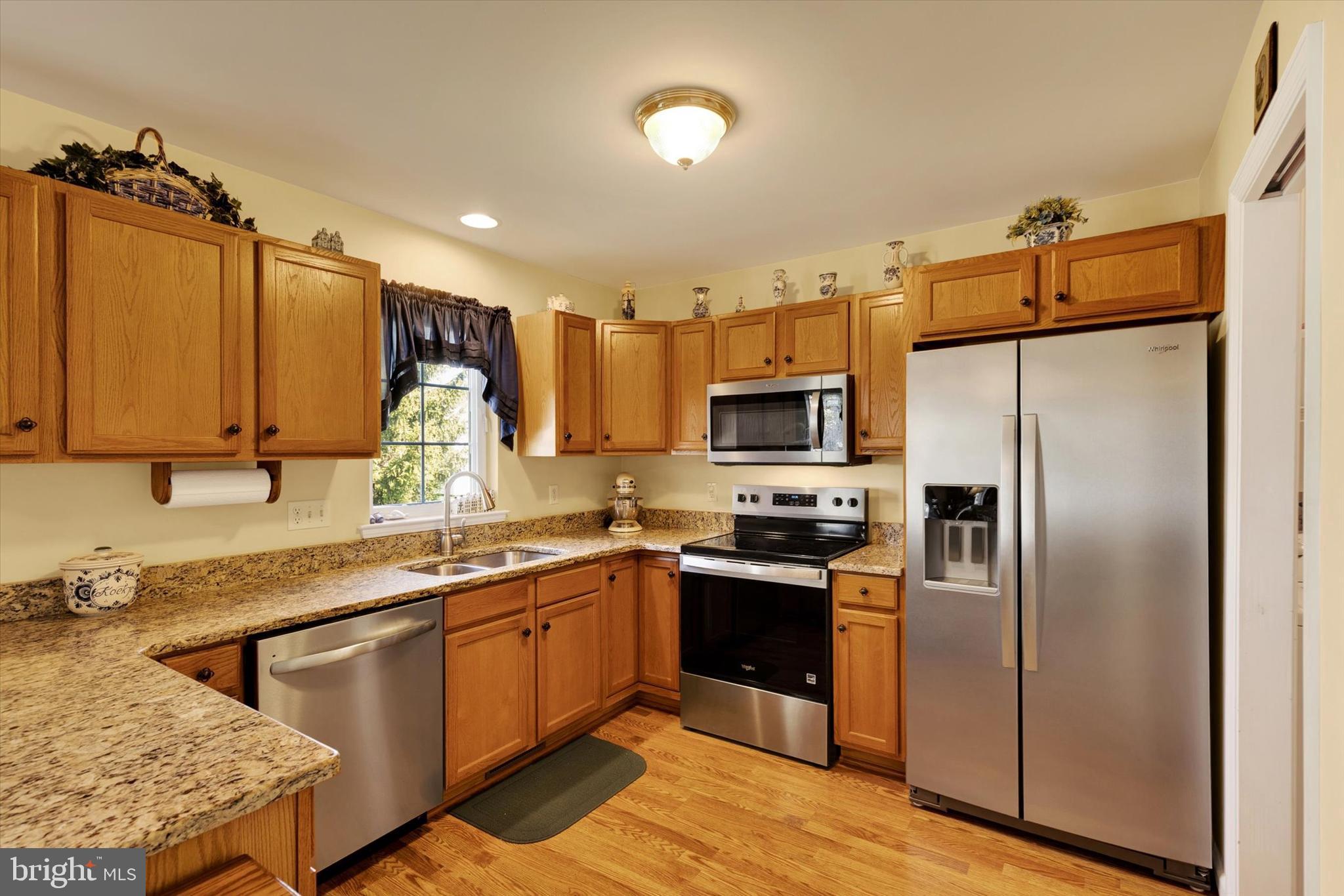 113 Hillcrest Road Marietta, PA 17547 - Photo 13 of 29 a kitchen with stainless steel appliances granite countertop a stove a sink dishwasher a refrigerator and cabinets with wooden floor