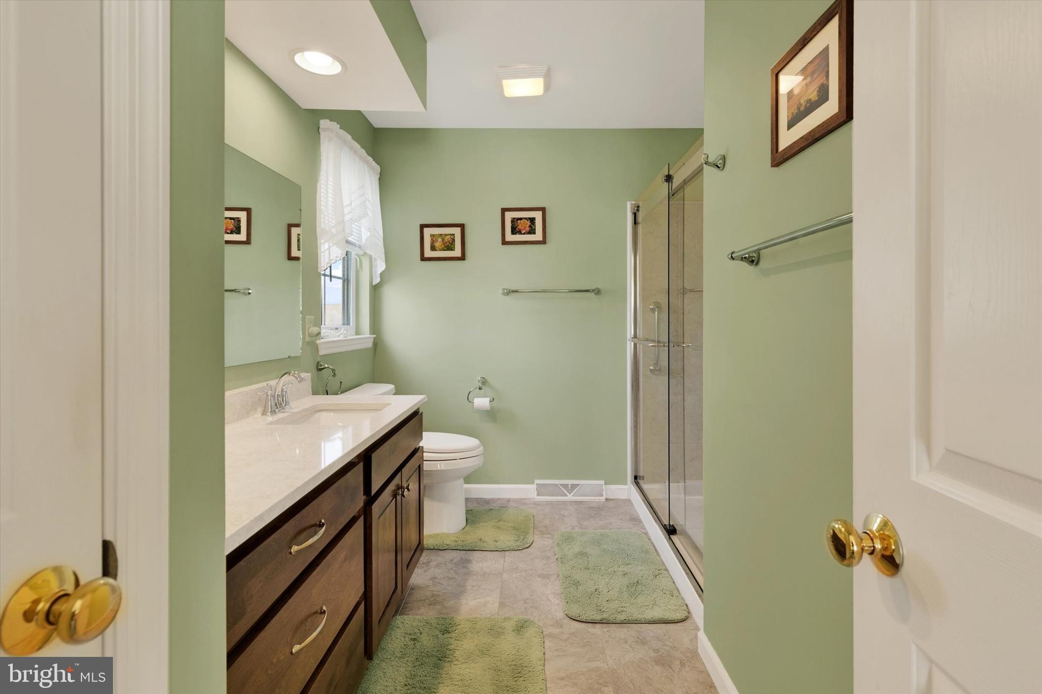 113 Hillcrest Road Marietta, PA 17547 - Photo 20 of 29 a bathroom with a granite countertop sink a toilet and shower