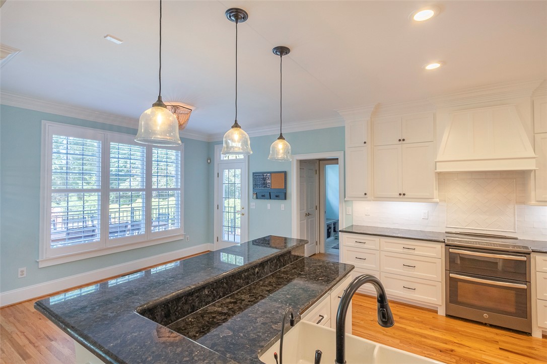 1104 Harpers Way Anderson, SC 29621 - Photo 9 of 50 This kitchen features a spacious island with ample counter space and sleek, modern appliances.