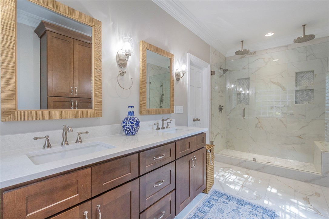 1104 Harpers Way Anderson, SC 29621 - Photo 21 of 50 This serene bathroom offers a luxurious escape with dual vanities and an expansive walk-in shower.