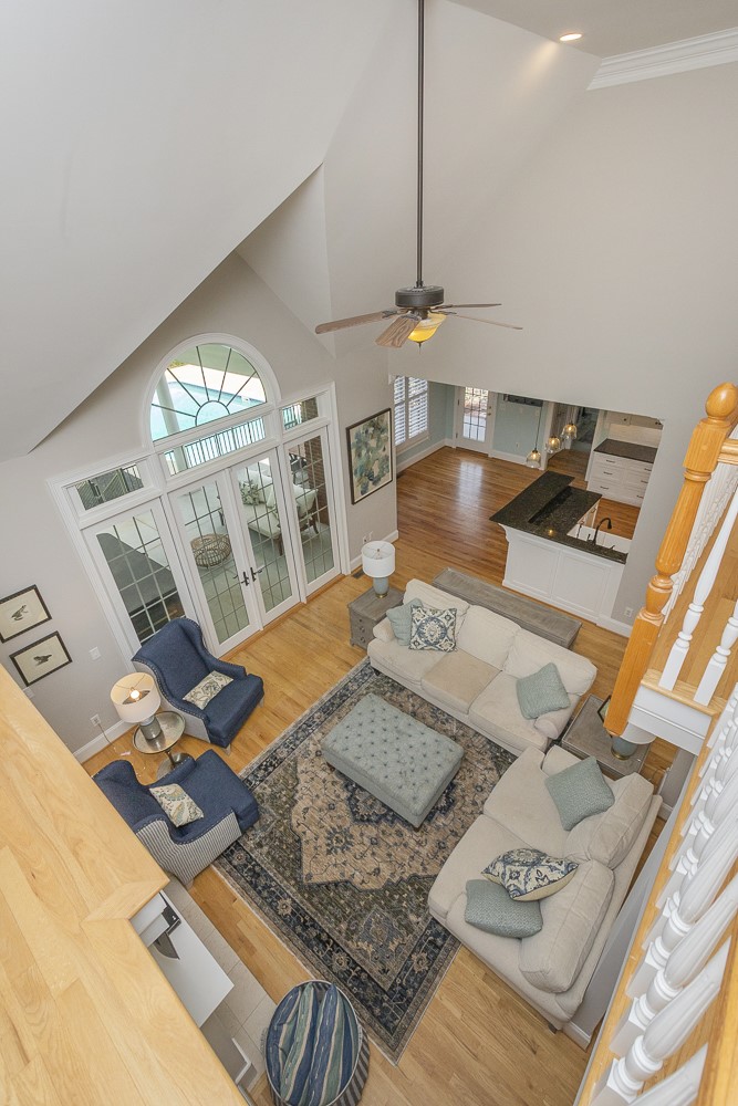 1104 Harpers Way Anderson, SC 29621 - Photo 23 of 50 This living room boasts high ceilings and elegant hardwood flooring, creating an inviting and expansive atmosphere.