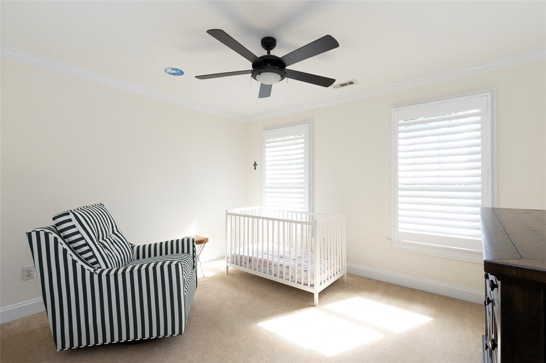 1104 Harpers Way Anderson, SC 29621 - Photo 25 of 50 This bright room features elegant crown molding and soft carpeting, creating a tranquil atmosphere.
