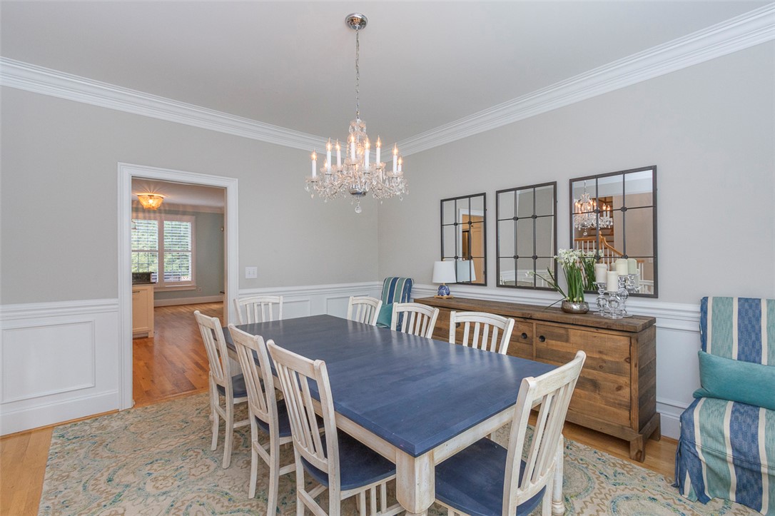 1104 Harpers Way Anderson, SC 29621 - Photo 3 of 50 This bright dining area offers elegant crown molding and wainscoting, perfect for entertaining.