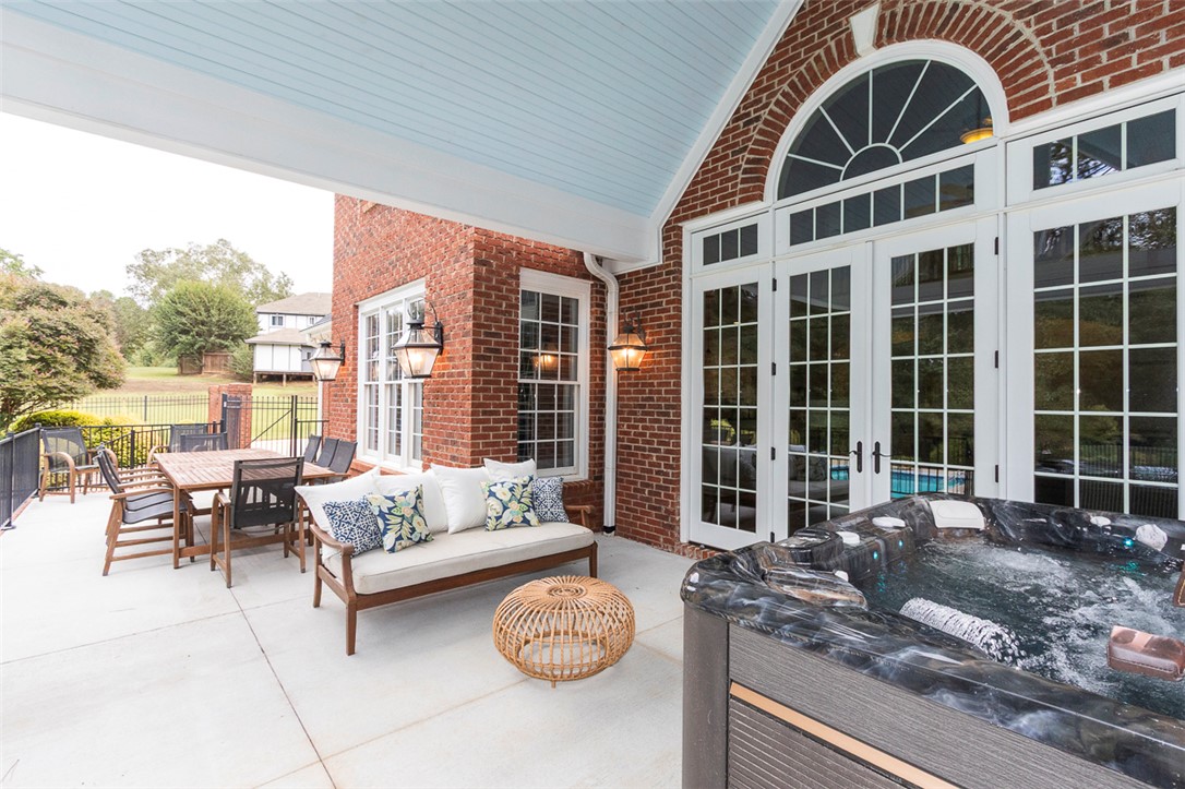 1104 Harpers Way Anderson, SC 29621 - Photo 36 of 50 An inviting outdoor patio, perfect for entertaining, features a spa alongside elegant french doors.