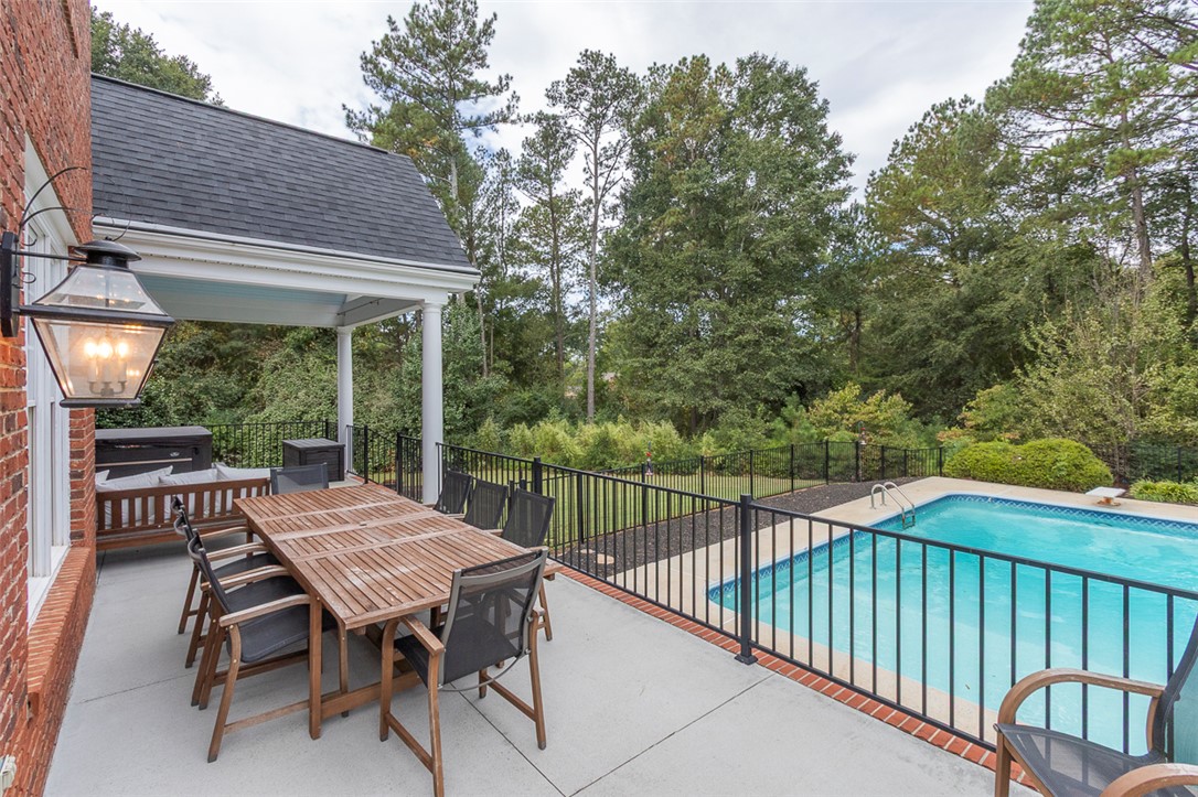 1104 Harpers Way Anderson, SC 29621 - Photo 38 of 50 This inviting patio with an outdoor dining area overlooks a refreshing swimming pool.