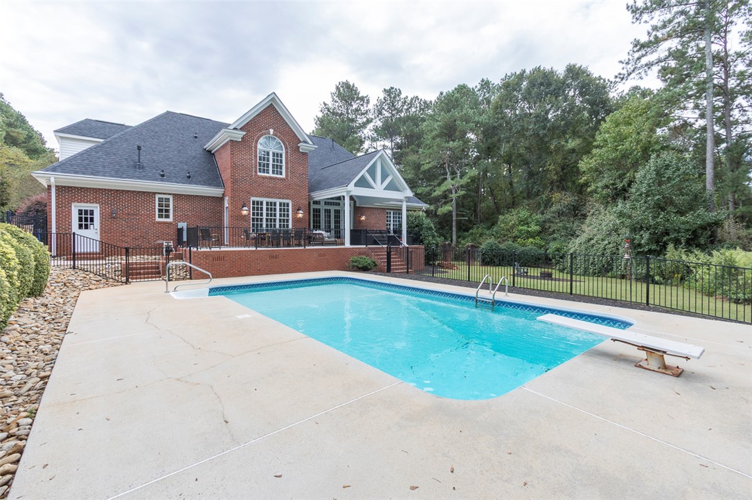 1104 Harpers Way Anderson, SC 29621 - Photo 40 of 50 This classic brick residence features a pristine pool, offering a private oasis.