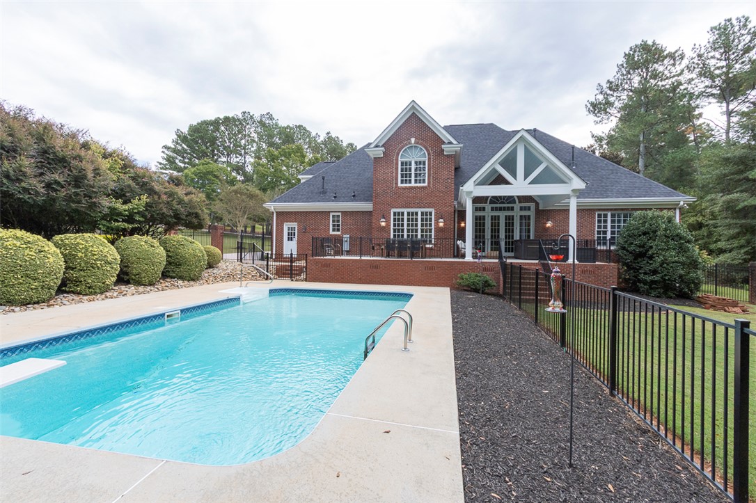 1104 Harpers Way Anderson, SC 29621 - Photo 41 of 50 This spacious brick home features a sparkling pool and inviting outdoor living areas.