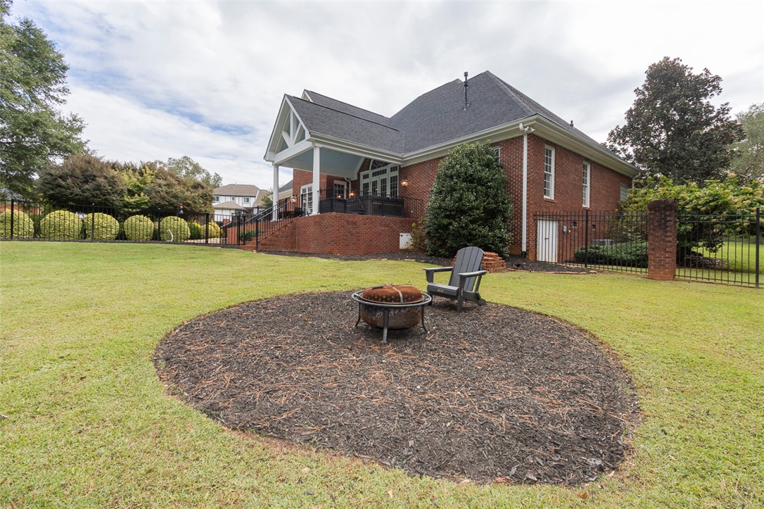 1104 Harpers Way Anderson, SC 29621 - Photo 44 of 50 This spacious lawn features a fire pit, ideal for outdoor gatherings and relaxation.