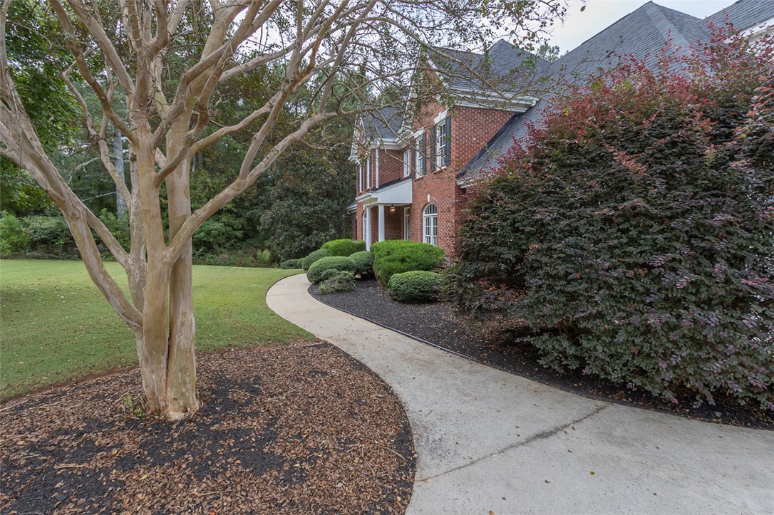 1104 Harpers Way Anderson, SC 29621 - Photo 48 of 50 A graceful pathway leads to this classic brick home, surrounded by mature landscaping and verdant lawn.