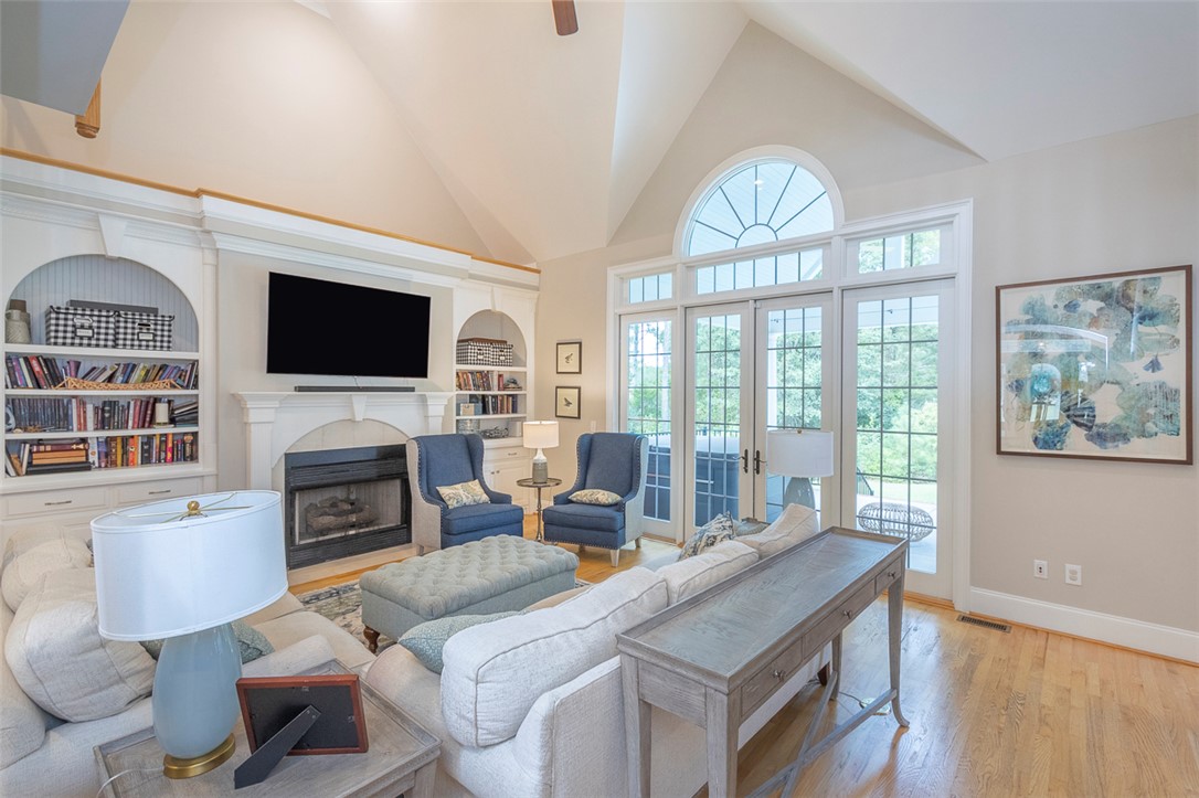 1104 Harpers Way Anderson, SC 29621 - Photo 6 of 50 This bright living space features hardwood flooring and a cozy fireplace, perfect for relaxation and gatherings.
