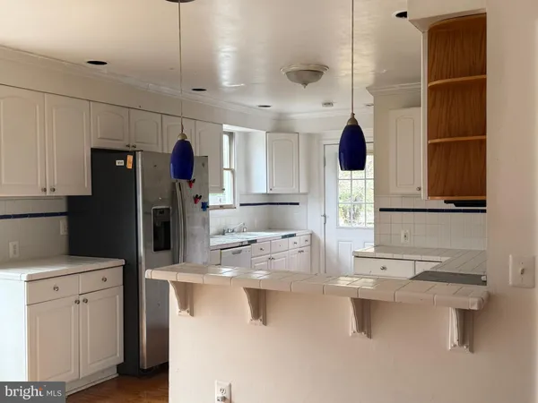 a kitchen with a sink and refrigerator