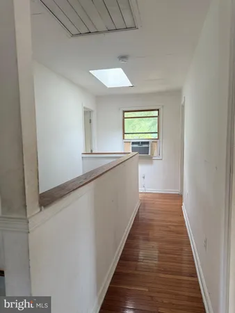 a view of hallway with wooden floor