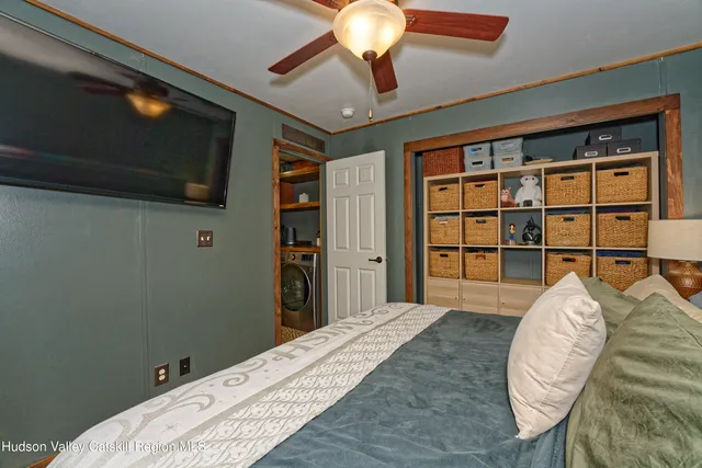 a bedroom with a bed and a flat screen tv