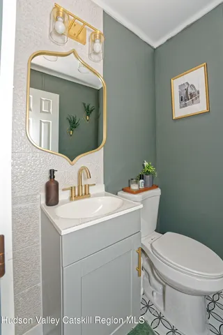 a bathroom with a toilet a sink and a mirror