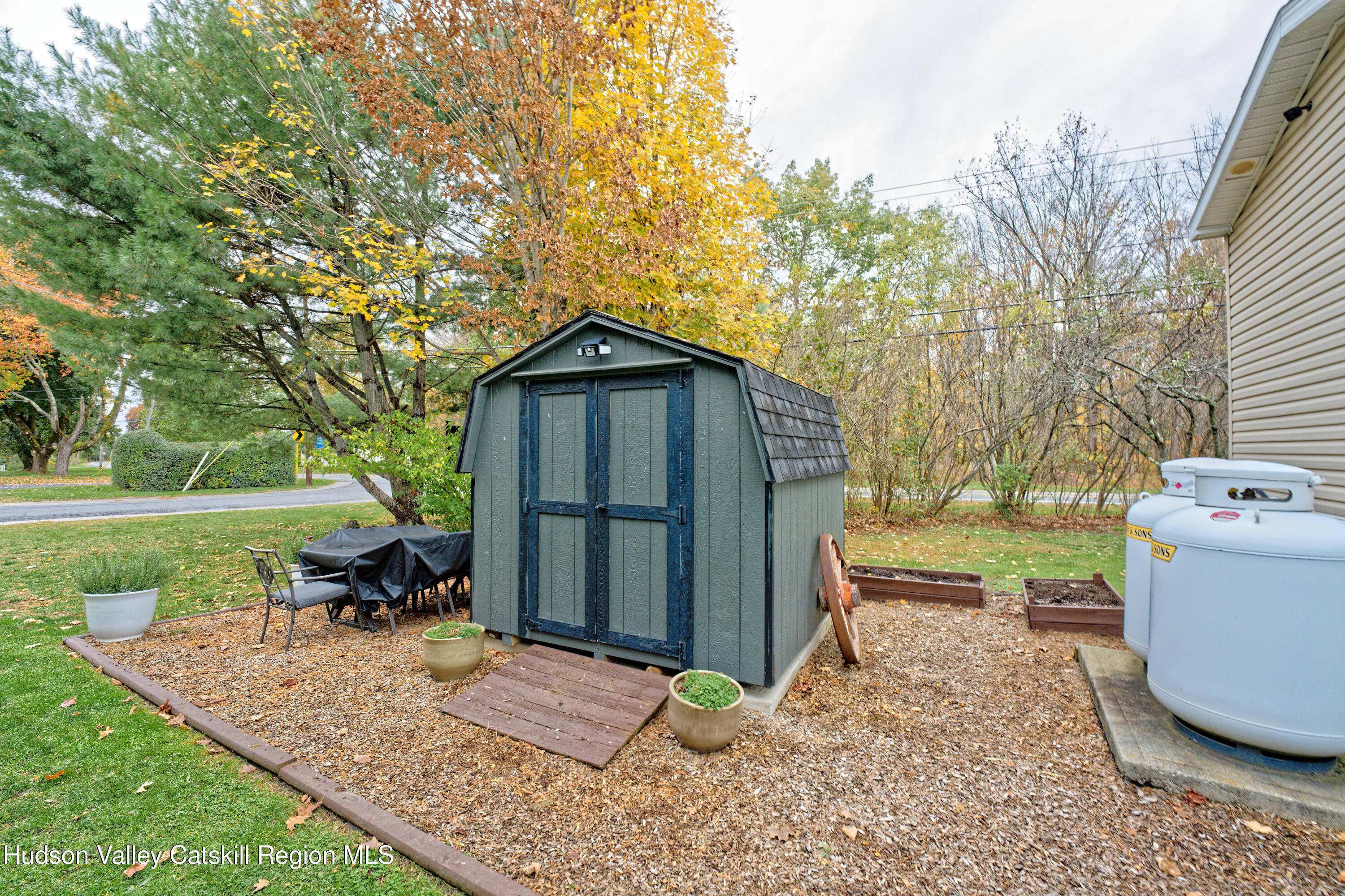 28 Matthew Drive, Unit 28 Castleton-on-Hudson, NY 12033 - Photo 26 of 28 a view of a backyard with table and chairs plants and large tree