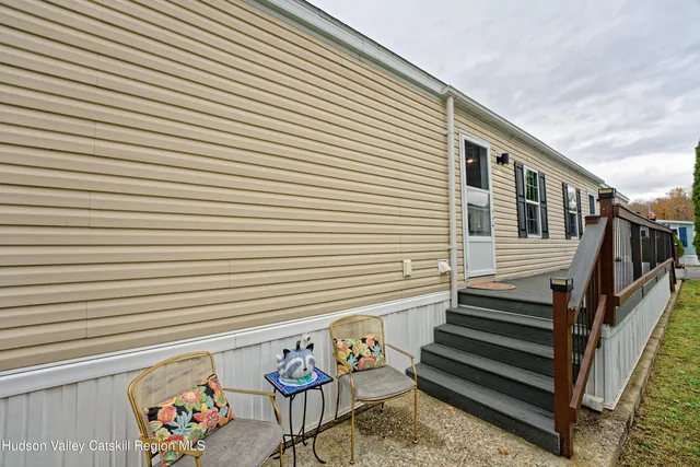 a view of a patio with wooden chairs