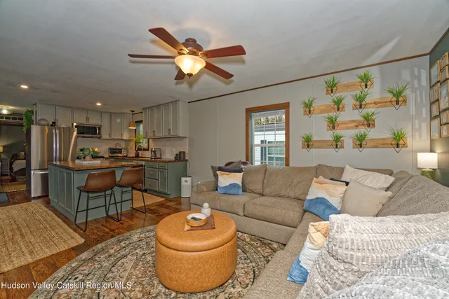 a living room with furniture and kitchen view
