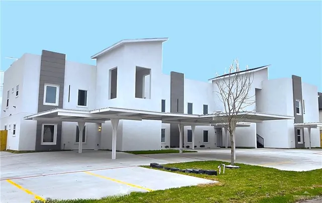 a view of a house with pool and chairs