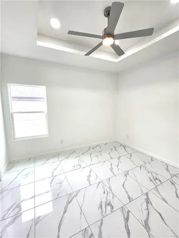 a view of a room window and a ceiling fan