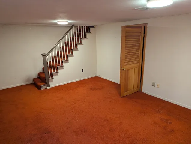 a view of an empty room with stairs