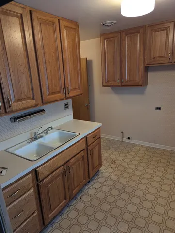a kitchen with a sink cabinets and utility