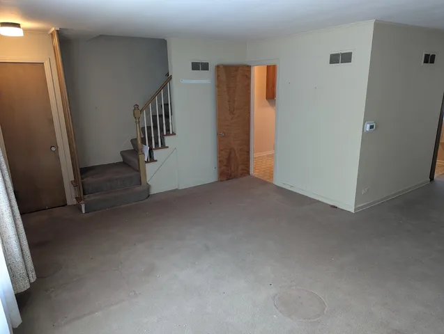 a view of an empty room with stairs