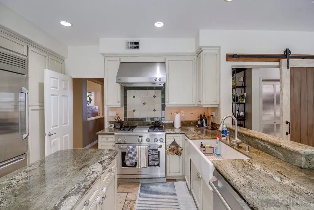 2305 Falkirk Row La Jolla, CA 92037 - Photo 12 of 36 a kitchen with a stove a sink and a refrigerator
