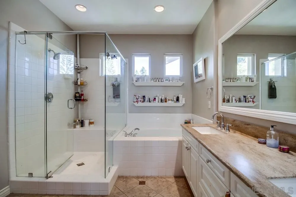 2305 Falkirk Row La Jolla, CA 92037 - Photo 33 of 36 a bathroom with a tub shower sink and mirror